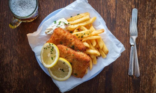 Authentic traditional British cuisine fish and chips served with an ice cold beer.